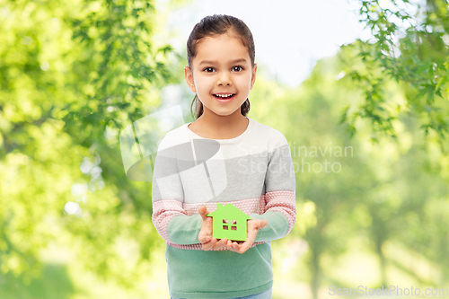 Image of smiling little girl holding green house icon