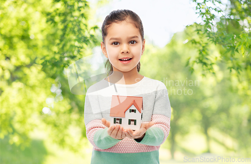 Image of smiling girl holding house model