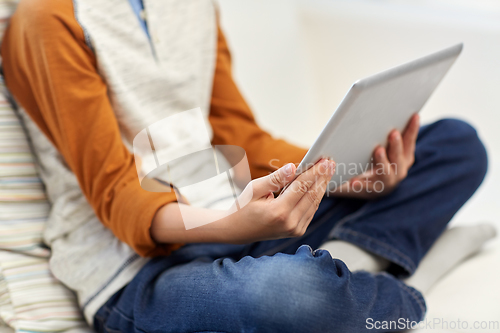 Image of close up of boy with tablet pc computer at home
