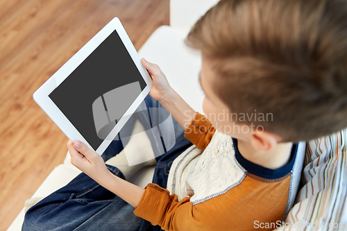 Image of close up of boy with tablet pc computer at home