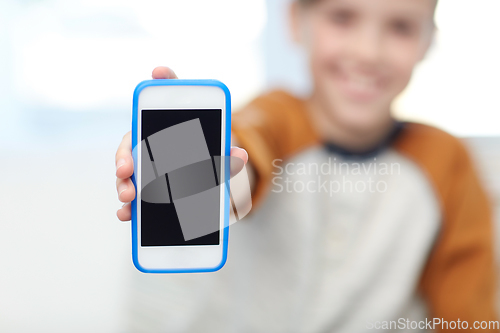 Image of close up of boy with smartphone at home