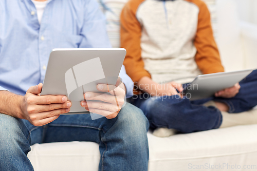 Image of father and son with tablet pc at home