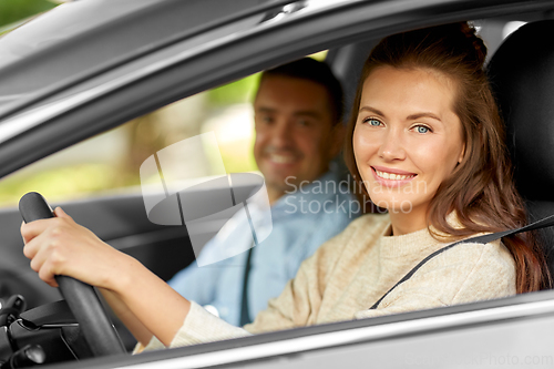 Image of car driving school instructor teaching woman