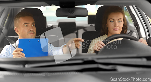 Image of car driving school instructor and young driver