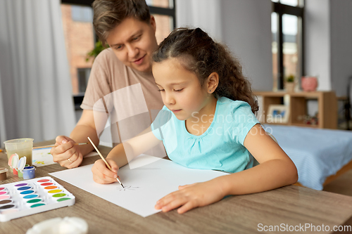 Image of happy father with little daughter drawing at home