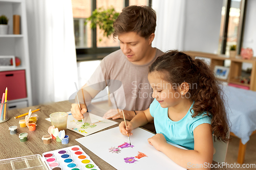 Image of happy father with little daughter drawing at home