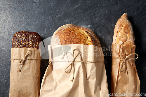 Image of close up of bread in paper bags on table