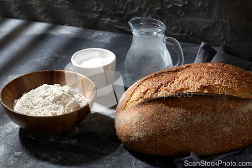 Image of bread, wheat flour, salt and water in glass jug