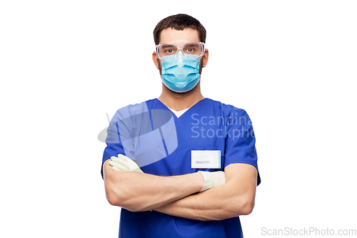 Image of male doctor in goggles, mask and gloves