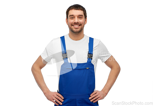 Image of happy smiling male worker or builder in overall