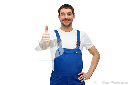 Image of happy male worker or builder showing thumbs up