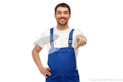 Image of happy male worker or builder pointing to camera