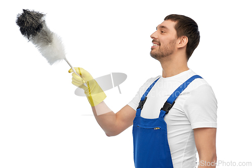 Image of happy male worker or cleaner with duster cleaning