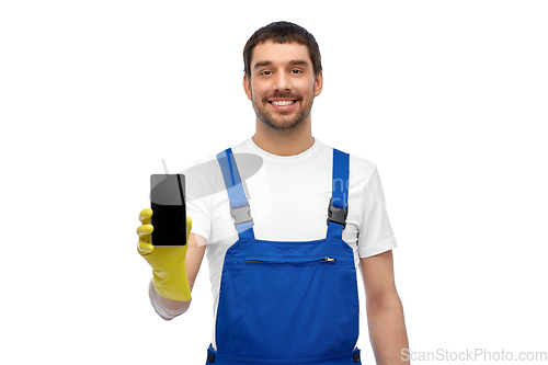 Image of happy male worker or cleaner showing smartphone