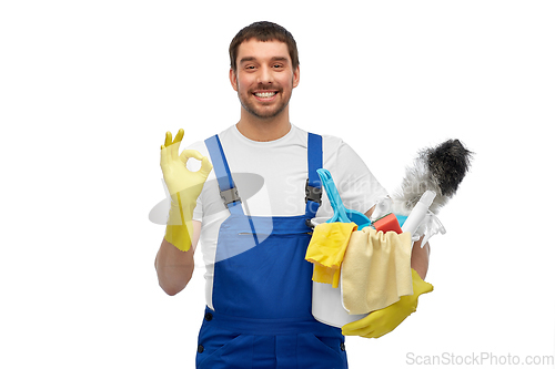 Image of male cleaner in overall with cleaning supplies