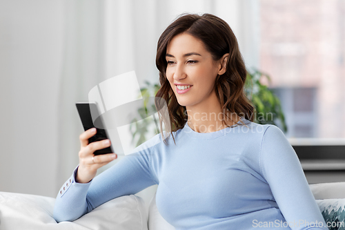 Image of woman with smartphone at home