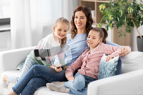 Image of happy family taking selfie by smartphone at home