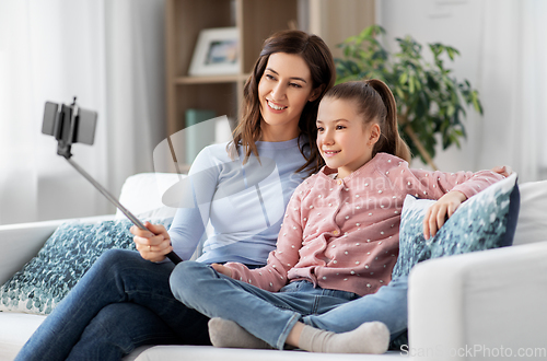 Image of happy family taking selfie by smartphone at home