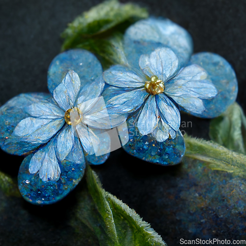 Image of Bunch of small blue forget me not flowers with leaves.