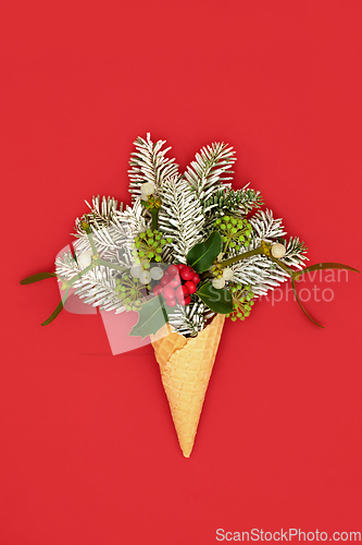 Image of Christmas Ice Cream Cone Surreal Concept with Winter Greenery 