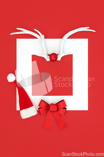 Image of Christmas Santa Hat Reindeer Antlers and Red Bow Background