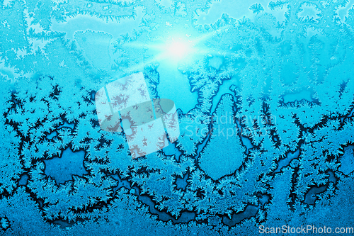 Image of Beautiful ice pattern and bright sunlight on winter glass