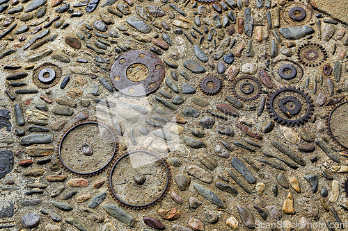 Image of Unusual floor with pattern from pebbles and metal details