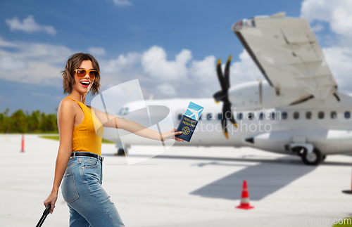 Image of happy woman with air ticket and immunity passport