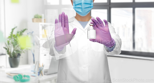 Image of close up of doctor with syringe shows stop gesture