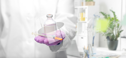 Image of close up of doctor with medicine and syringe