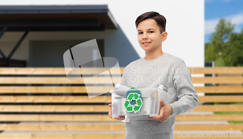 Image of smiling boy sorting metallic waste over house