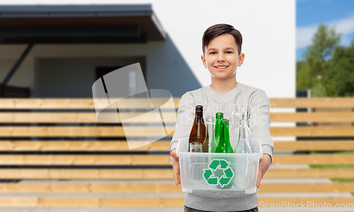 Image of smiling boy sorting glass waste over house