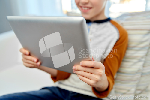 Image of close up of boy with tablet pc computer at home