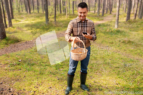 Image of man using smartphone to identify mushroom