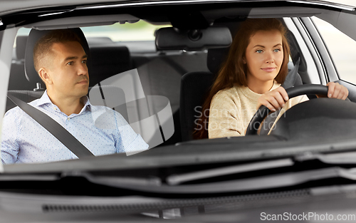 Image of car driving school instructor teaching woman