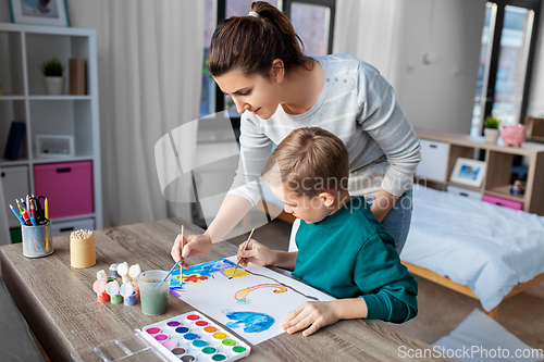 Image of mother and son with colors drawing at home