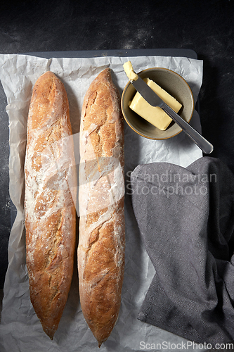 Image of close up of bread, butter and knife on towel