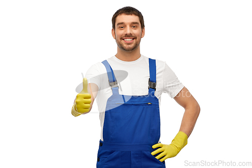 Image of happy male worker or cleaner in overall and gloves