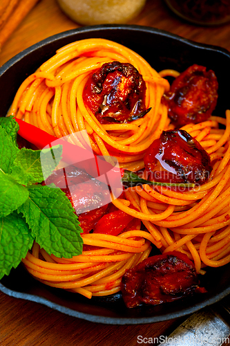 Image of italian spaghetti pasta and tomato with mint leaves