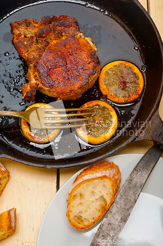 Image of pork chop seared on iron skillet