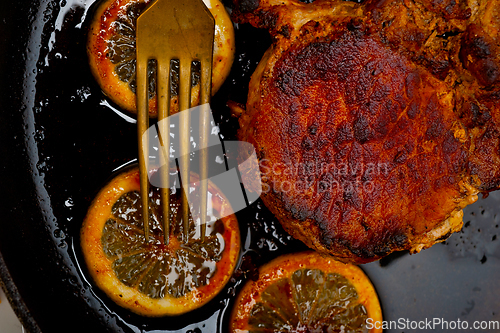 Image of pork chop seared on iron skillet