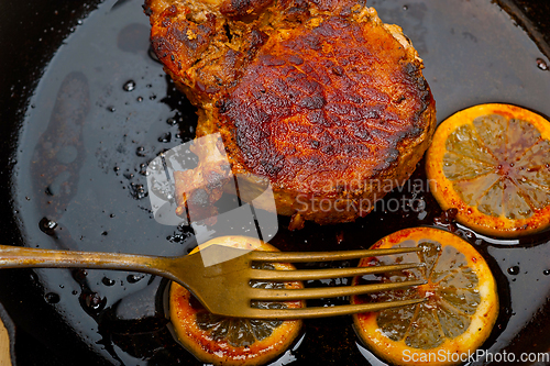 Image of pork chop seared on iron skillet