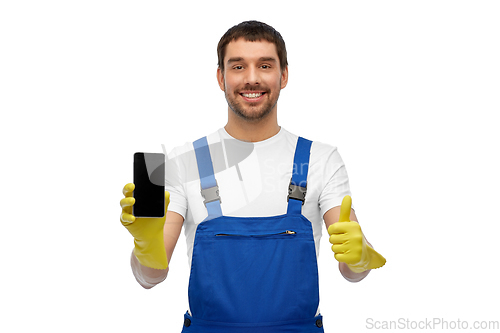 Image of happy male worker or cleaner showing smartphone