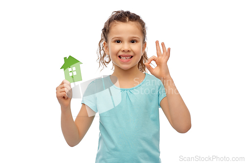 Image of happy little girl with green house icon showing ok