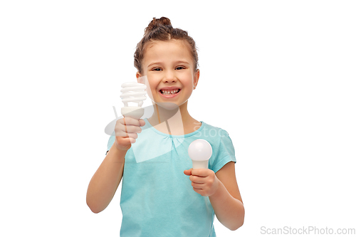 Image of smiling girl comparing different light bulbs