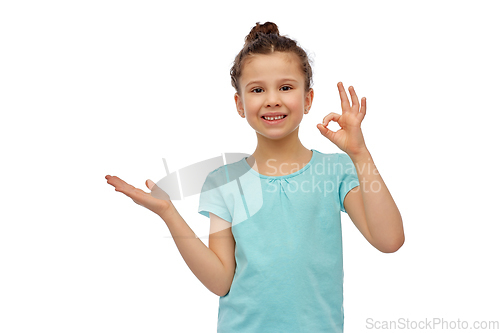 Image of happy smiling girl holding something imaginary