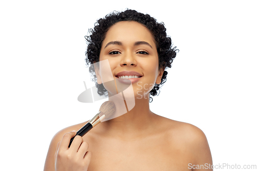 Image of woman with make up brush applying shimmer to skin