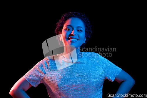 Image of african woman over neon lights on black background