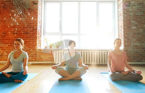 Image of group of people meditating at yoga studio