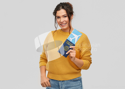 Image of happy woman with air ticket and immunity passport